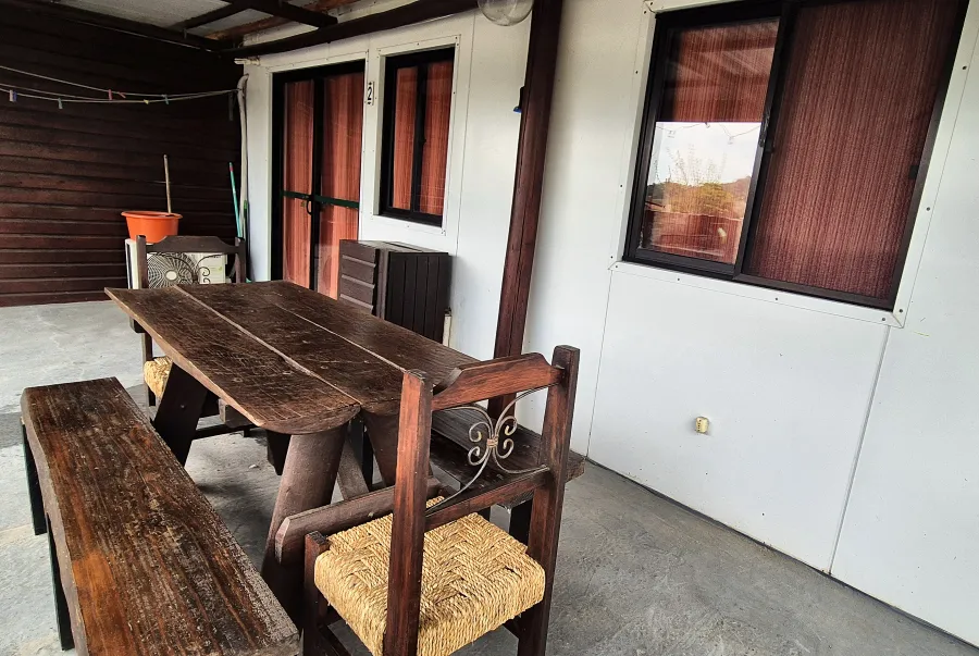 Mesa de madera y sillas en la galería